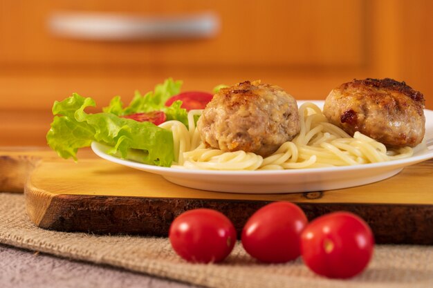 Polpette di carne pronti con insalata in un piatto sul tavolo.