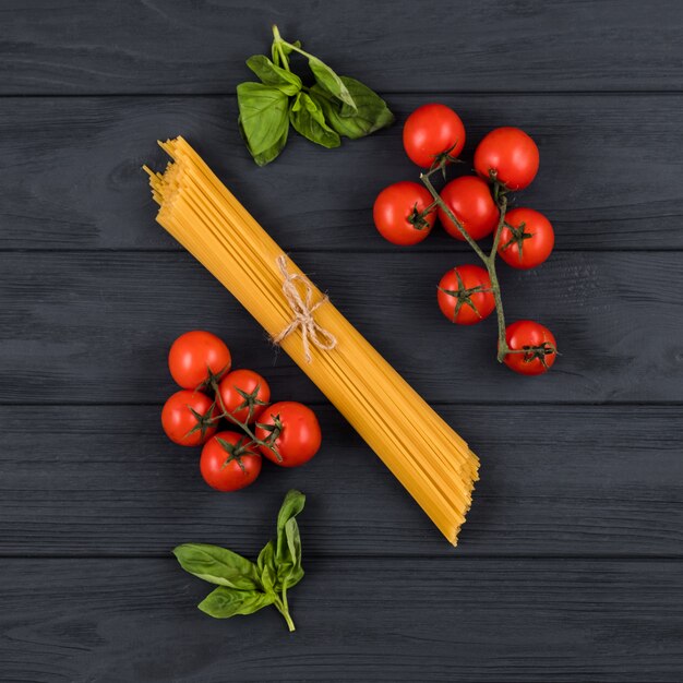 Pomodori, basilico, spaghetti. Vista dall'alto. Concetto di cucina italiana.