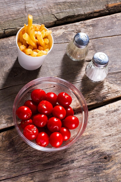 Pomodori e patatine al sale Pepe e pomodori a tavola Alimenti trasformati e verdure fresche Fai la tua scelta