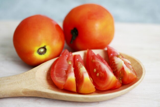 Pomodori freschi sul cucchiaio di legno