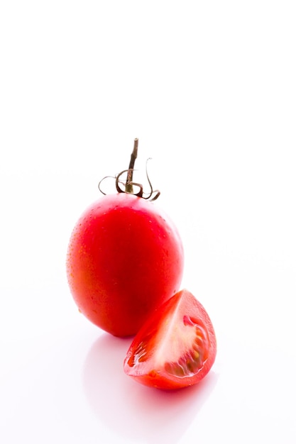 Pomodori Roma organici su sfondo bianco.