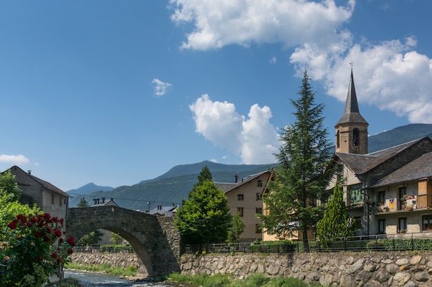 Ponte, edifici e campanile prima delle montagne