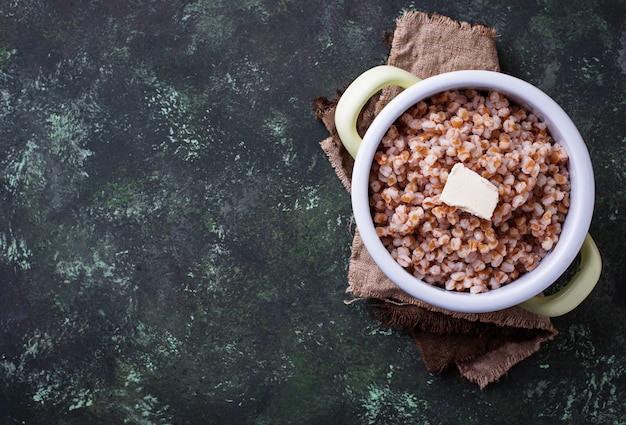 Porridge di orzo con burro in vaso verde