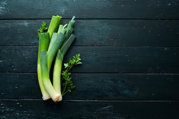 Porro verde crudo su sfondo nero Verdure per un'alimentazione sana Vista dall'alto Spazio per la copia gratuito