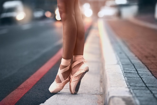 Porta la tua passione con te ovunque tu vada Inquadratura ritagliata di una ballerina in piedi in punta di piedi su uno sfondo urbano