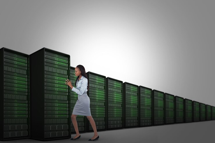 Photo portrait of a young businesswoman pushing a panel against server tower