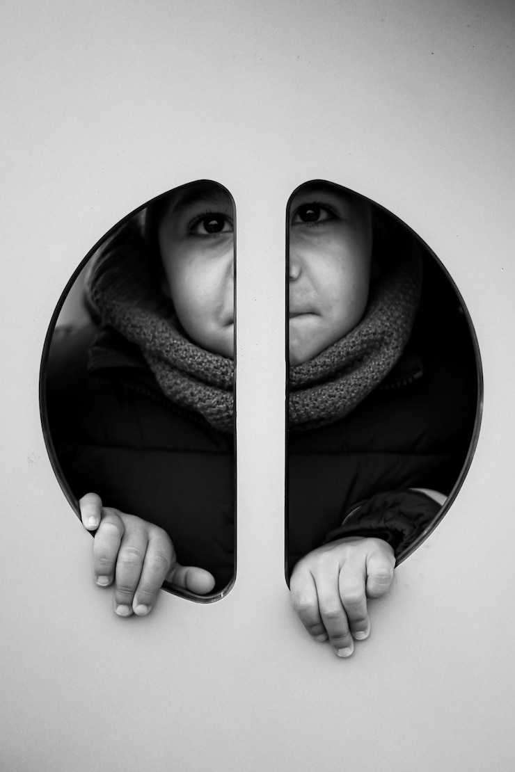 Photo portrait of boy looking through hole