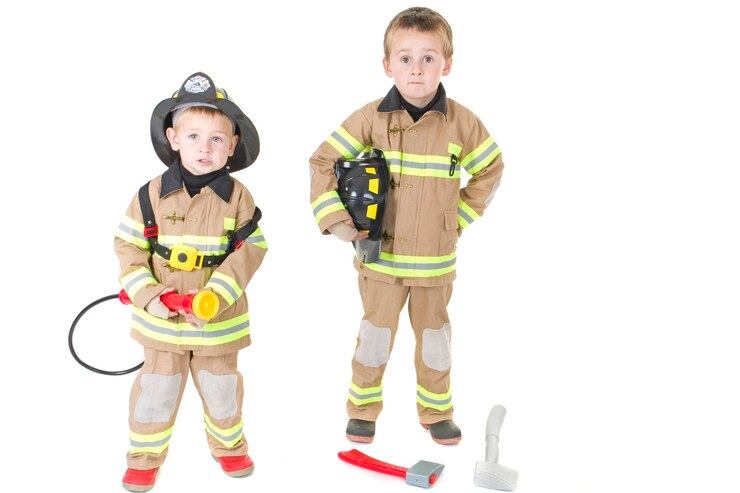 Photo portrait of cute brothers in firefighter uniform standing against white background
