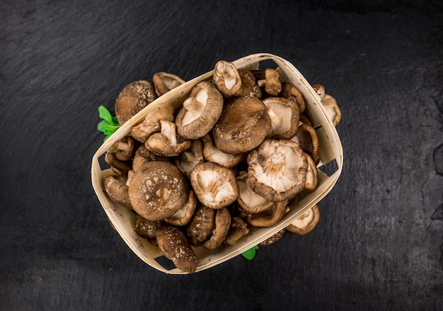 Porzione di funghi Shiitake crudi su una lastra di ardesia