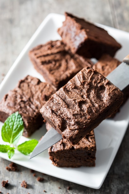 Porzioni di brownie al cioccolato su fondo di legno