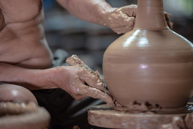 Potter che fa terraglie su un tornio nella fabbrica