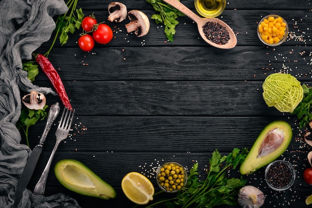 Preparazione per la cottura Avocado pomodorini piselli e nocciola Su uno sfondo di legno Vista dall'alto Spazio libero per il testo