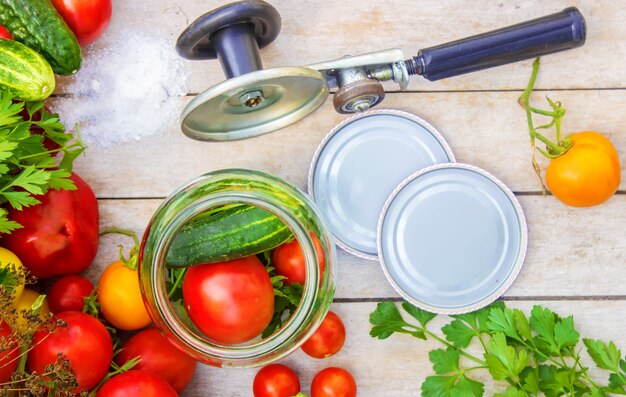 Preservation, pickling vegetables of tomatoes and cucumbers. Selective focus.