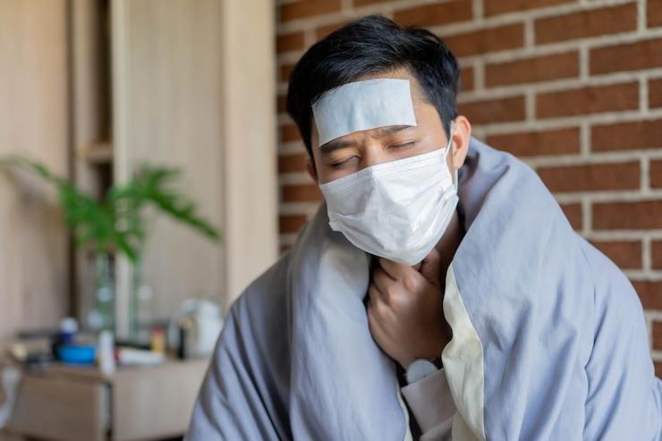 Photo pria asia bangun tidur merasa sakit tenggorokan di area karantina kamar tidur untuk konsep pencegahan virus corona