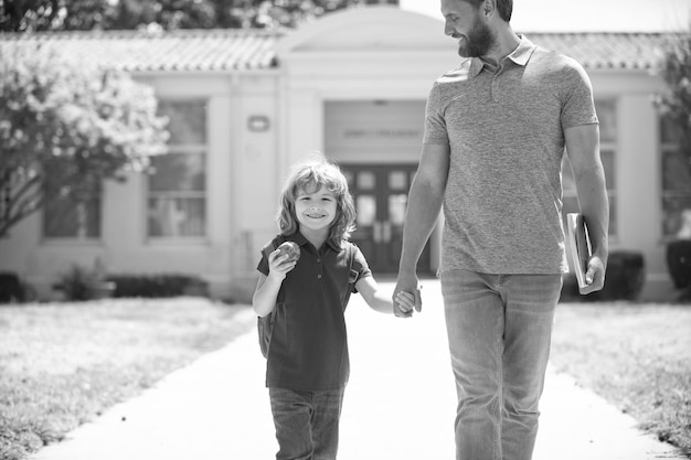 Primo giorno di scuola padre e figlio tornano da scuola felice famiglia valore