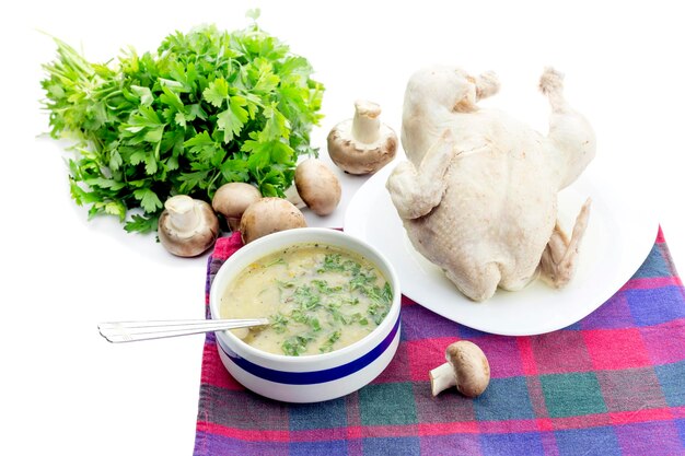 Primo pasto Zuppa di funghi in una ciotola e pollo bollito su un primo piano del tavolo su uno sfondo bianco