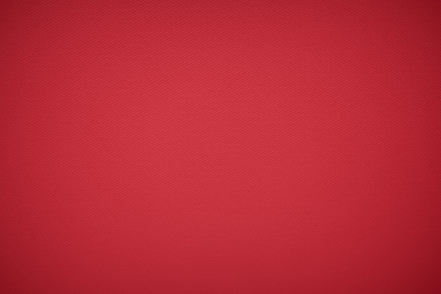 Primo piano del materiale tessile in tessuto rosso come trama o sfondo Sfondo rosso con trame e vignetta Vista ravvicinata della trama del tessuto di lana rossa