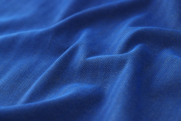 Primo piano del modello di sfondo texture tessuto a spina di pesce nero e blu di sfondo panno ondulato