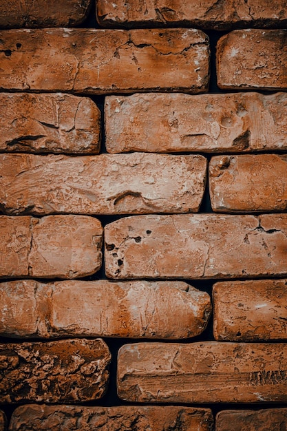 Primo piano del muro di mattoni Fondo rosso astratto del mattone