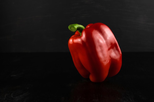 Primo piano del peperone dolce rosso su un fondo di legno scuro