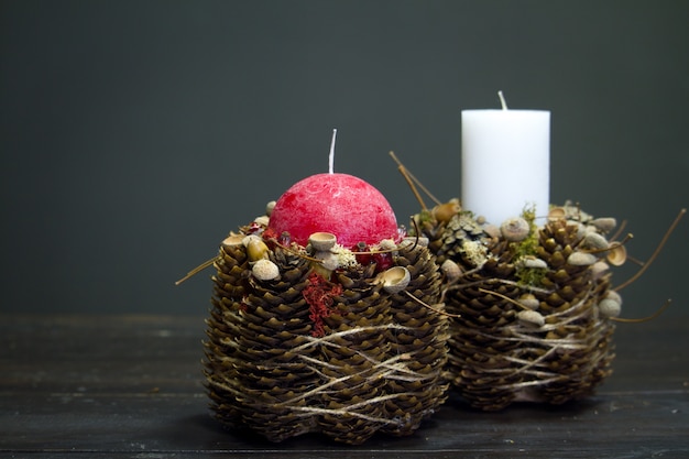 Primo piano della decorazione di inverno con candele su una superficie di legno