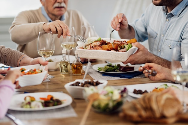 Primo piano della famiglia multigenerazionale che mangia pranzo al tavolo da pranzo