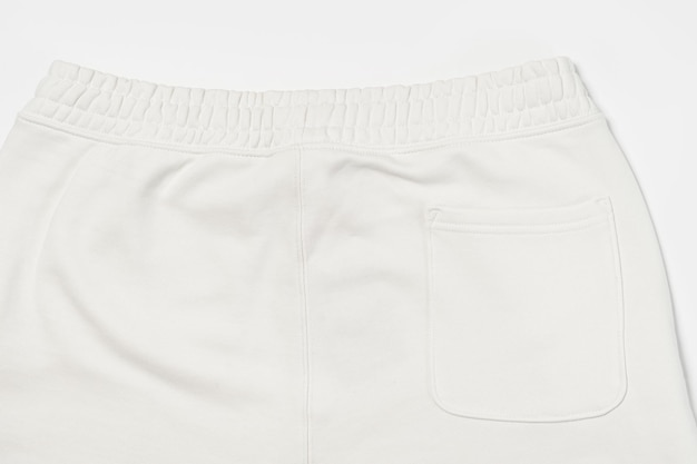 Primo piano della struttura del tessuto di cotone dei pantaloni della tuta bianchi