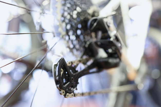 Primo piano delle catene di ferro sulla ruota posteriore della riparazione e manutenzione della bicicletta del concetto di biciclette