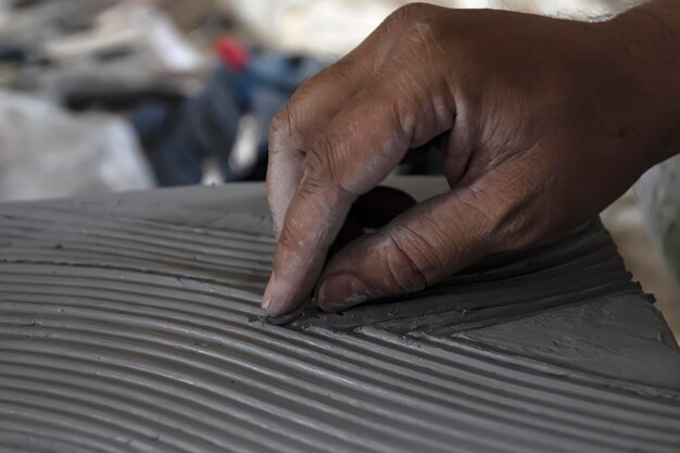 Primo piano dello scultore maschio che fa arte sull'argilla usando le mani Stampaggio maestro dell'argilla Modellazione dell'argilla