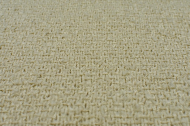Primo piano di struttura di lana beige lavorata a maglia