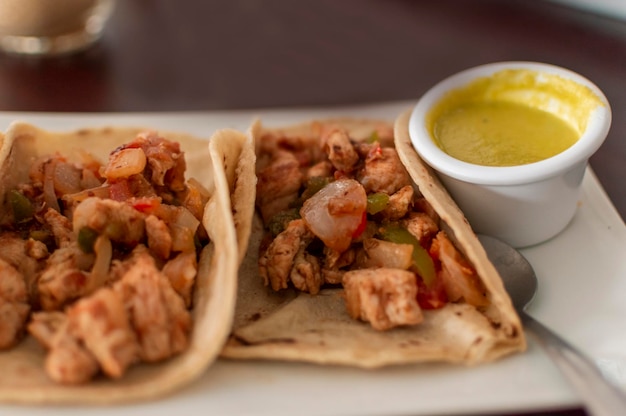 Primo piano di tacos di pollo tacos di pollo con salsa serviti sul tavolo tacos serviti sul tavolo