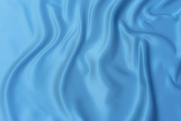 Primo piano di tessuto blu naturale o panno dello stesso colore Tessuto di cotone naturale, seta o lana o materiale tessile di lino Sfondo tela blu
