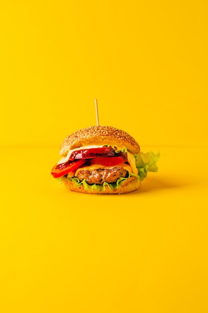 primo piano di un hamburger su uno sfondo giallo
