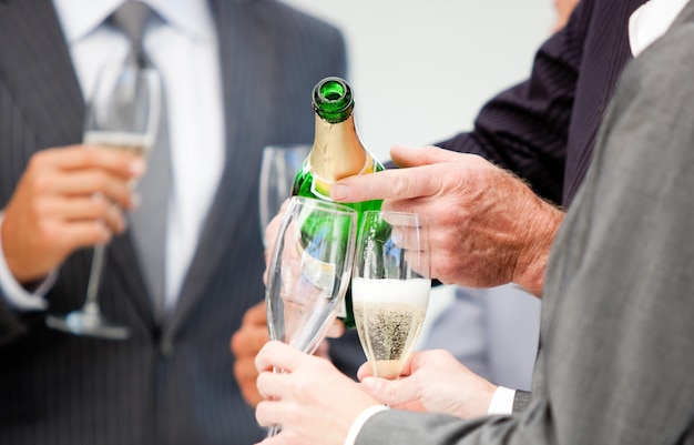 Primo piano di un uomo d&#39;affari che serve Champagne