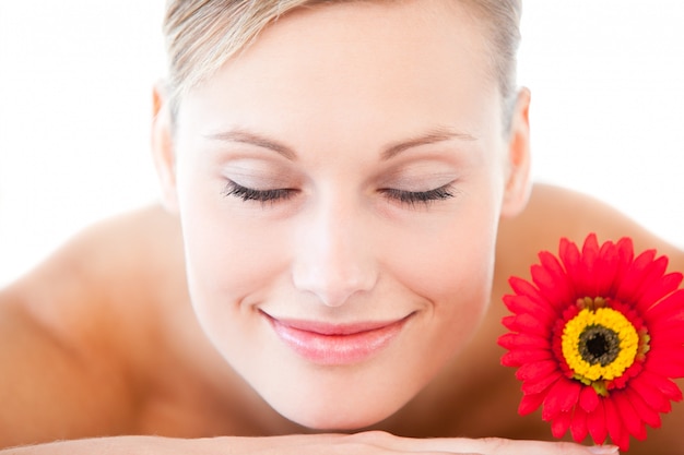 Primo piano di una donna sorridente che si trova su un lettino da massaggio con un flusso