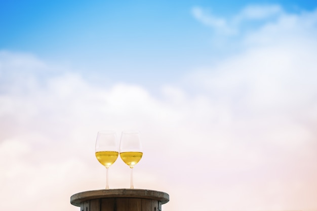 Primo piano due bicchiere di vino bianco sul tavolo al terrazzo sul cielo