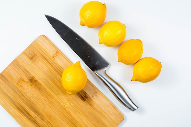 Primo piano immagine del capo coltello e limone sul tavolo bianco