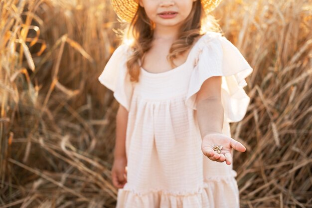 primo piano palmo della bambina mano con chicchi di grano