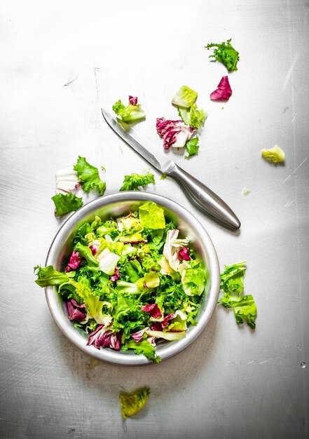 Primo piano su insalata di verdure fresche con coltello