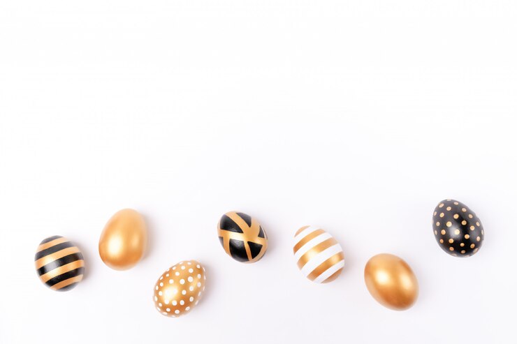 Priorità bassa di Pasqua o concetto di pasqua. Uova decorate dorate di Pasqua isolate su fondo bianco
