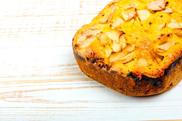 Prodotti da forno freschi. Torta al forno con le mele su di legno bianco