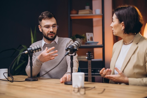 professional podcasters recording audio using studio microphones within dynamic radio station workspace