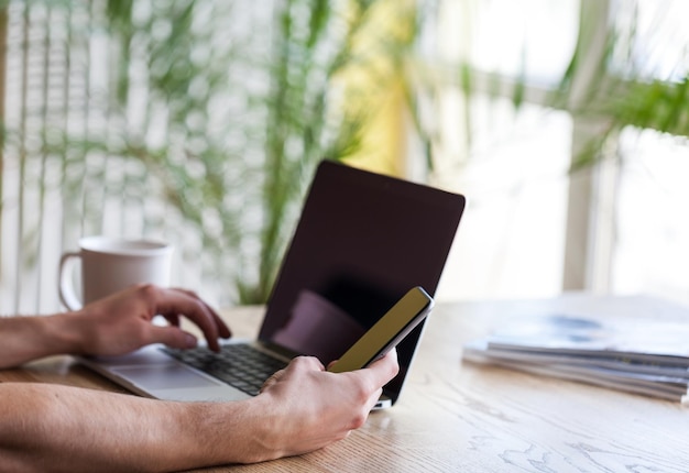 Professionista al lavoro Vista dall'alto dell'uomo che lavora sul laptop mentre è seduto al suo posto di lavoro