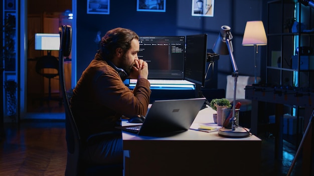 programmer removing headphones to better concentrate on difficult it task