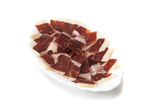 Prosciutto iberico isolato su sfondo bianco Concetto di specialità gastronomiche spagnole