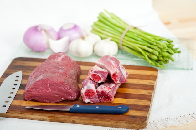 Prossimo piano della carne sul tavolo da taglio con le verdure