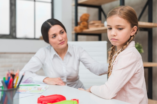 Psicologo femminile che consola la ragazza depressa nell&#39;ufficio