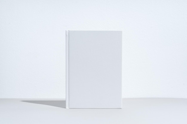 Quaderno bianco con copertina rigida su sfondo grigio