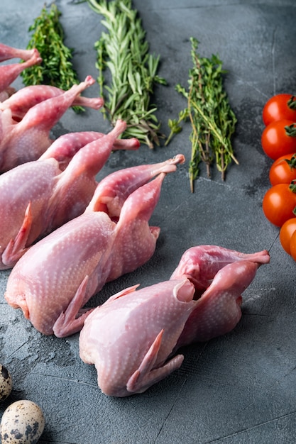 Quaglie fresche di carne cruda pronte per la cottura, sul tavolo grigio