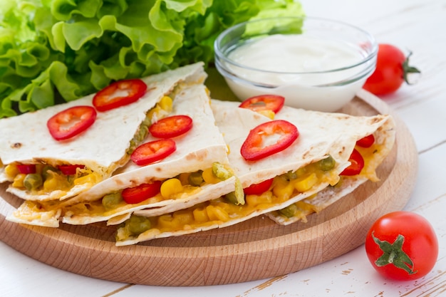 Quesadilla con panna acida, insalata e pomodori